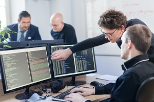 people looking at desktop screen