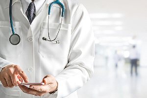 A doctor checking telehealth software options for his healthcare center