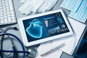 A tablet that has Telehealth Software installed and doctor tools on gray surface