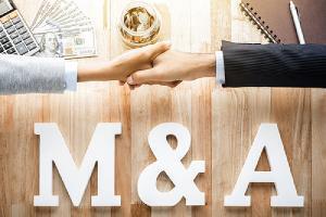 Business partners shaking hand and M&A integration planning on the foreground