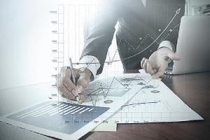 Businessman with business graph information. M&A integration may require bank leaders to develop new business processes