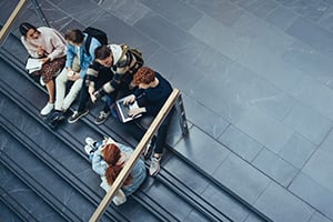 College students sitting on a staircase at college campus