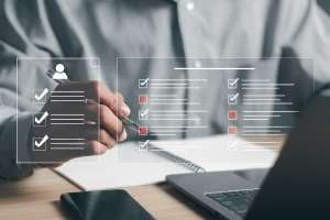 Human services professional writing on a checklist
