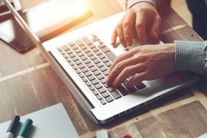 Man typing on computer image