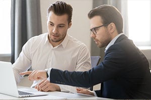 Manager going over cyber risk management plan with employee
