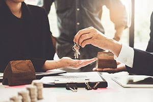 Real estate firm handing home owner their keys