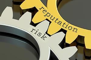 Reputation risk concept on the gearwheels. Reputational damage caused by cyberattacks can be devastating