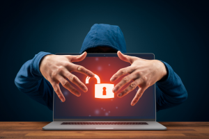 SPRS CMMC- a person in a hoodie with a laptop