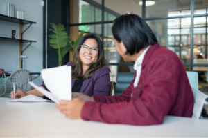 Two associates are talking at work.