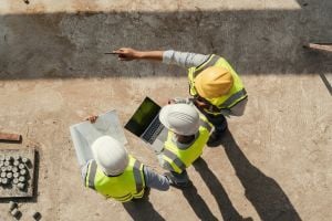 Construction workers at job site looking around