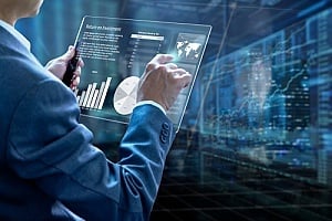 a bank leader reviewing financial analytics on a clear tablet