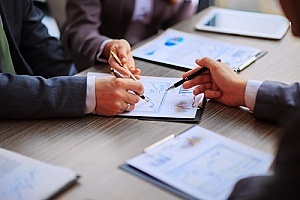a cybersecurity advisor reviewing a cybersecurity checklist with a business owner