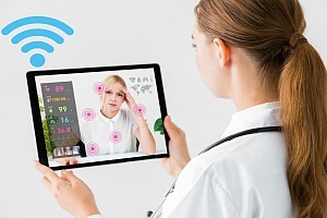 a doctor conducting remote patient monitoring from her smart device
