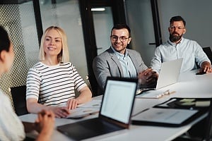 a group of executives at an organization that is collaborating with a new outsourced CIO