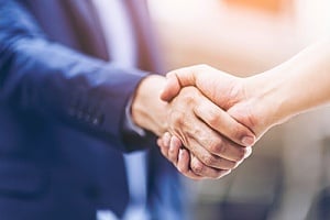 a handshake between a new CIO and the owner of a company