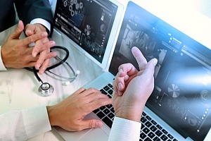 a health it professional discussing population health with a colleague