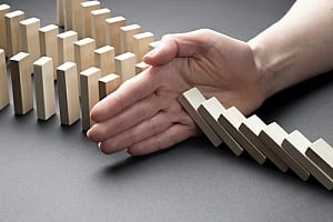 Hand stopping falling blocks for crisis prearedness