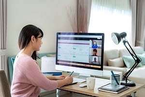 a person implenting crm at her desk to get return on investment