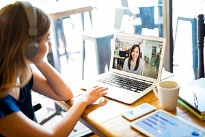 a person working together with a coworker in a remote work environment