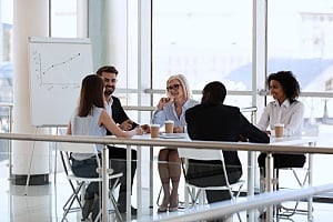 a team of executives who are discussing business processes with an outsourced CIO