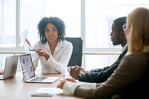 an it leader in a feedback meeting with coworkers