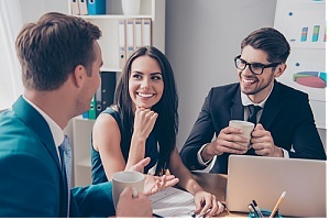 Cheerful employees at table 