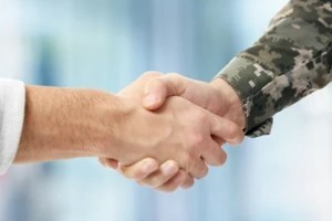 civilian and army officer shaking hands