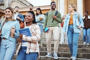 college students walking down the stairs to class