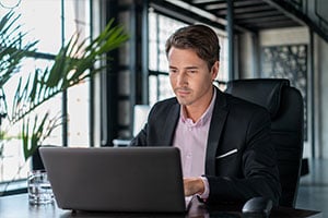 employee typing on laptop