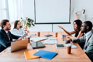 employees speaking in a meeting about change management