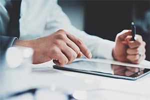 healthcare provider typing on ipad