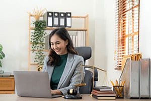 Local government worker in office typing on laptop