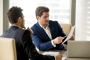 Man identifying risks to colleague 