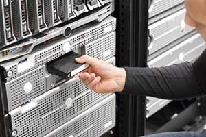 man in server room performing data recovery after a data breach