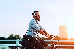 man listening to a podcast while riding his bike to work