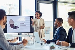 Business executives in a meeting looking at powerpoint
