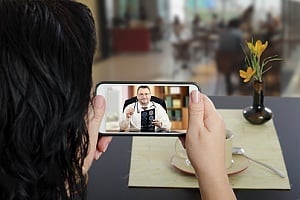 patient talking to a doctor through telehealth