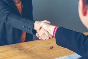 people shaking hands with eachother