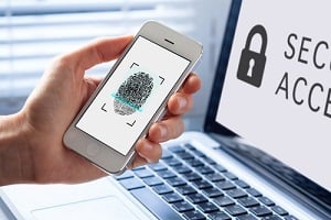 person using fingerprint scanning on mobile phone at telehealth cybersecurity requirements
