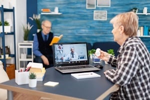 senior woman showing pills bottle at a telehealth cybersecurity requirements