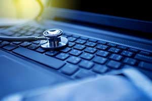 stethoscope on a laptop depicting hardware review as part of an IT due diligence checklist