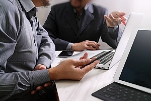 two business owners meeting to review and manage their IT portfolio