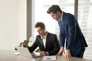 two workers noticing the benefits of a software evaluation